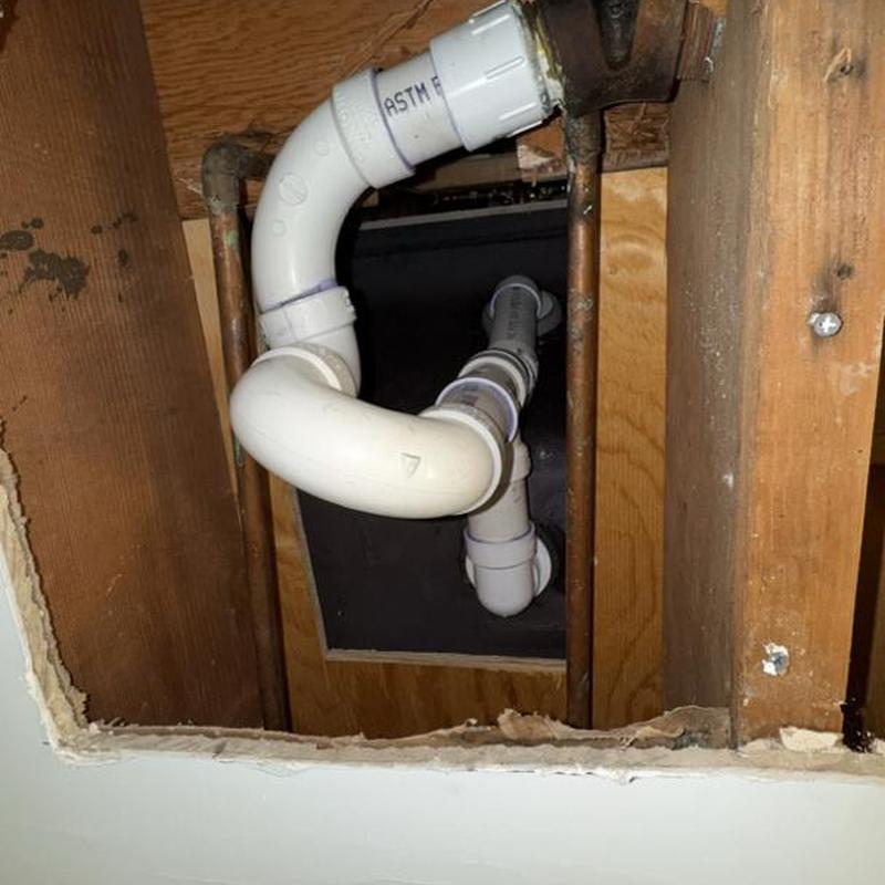 Tub drain and overflow piping installation under floor