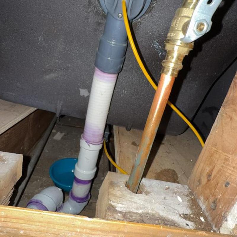 Tub drain and overflow pipe installation under floor joists