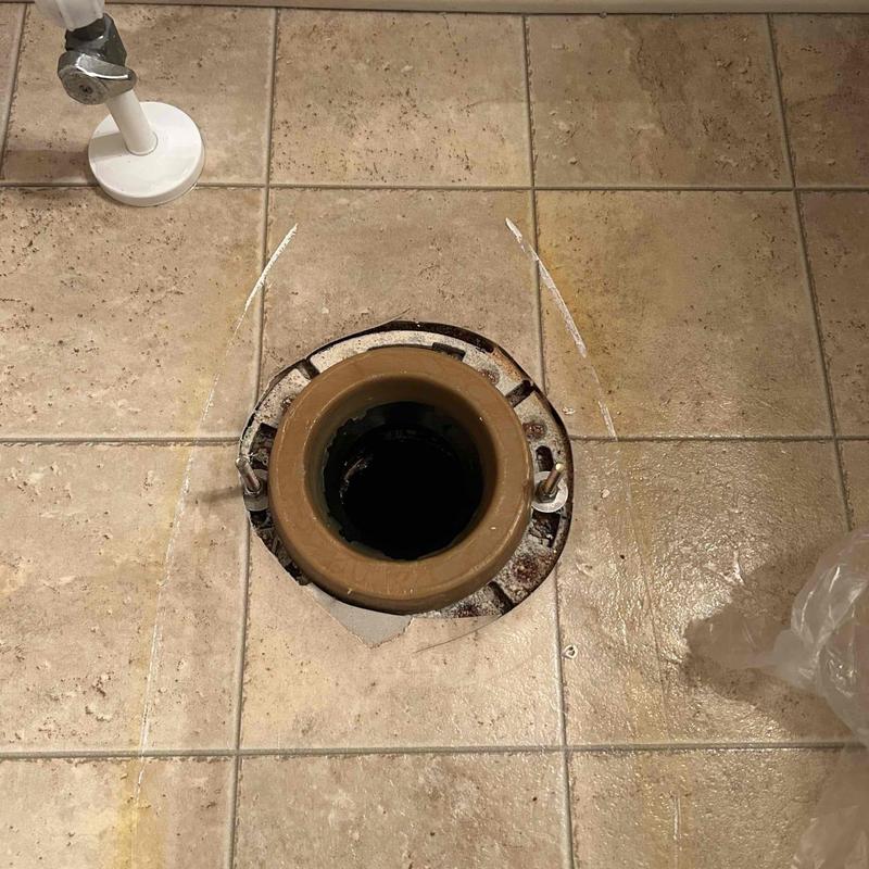 Toilet flange on tiled floor before installation