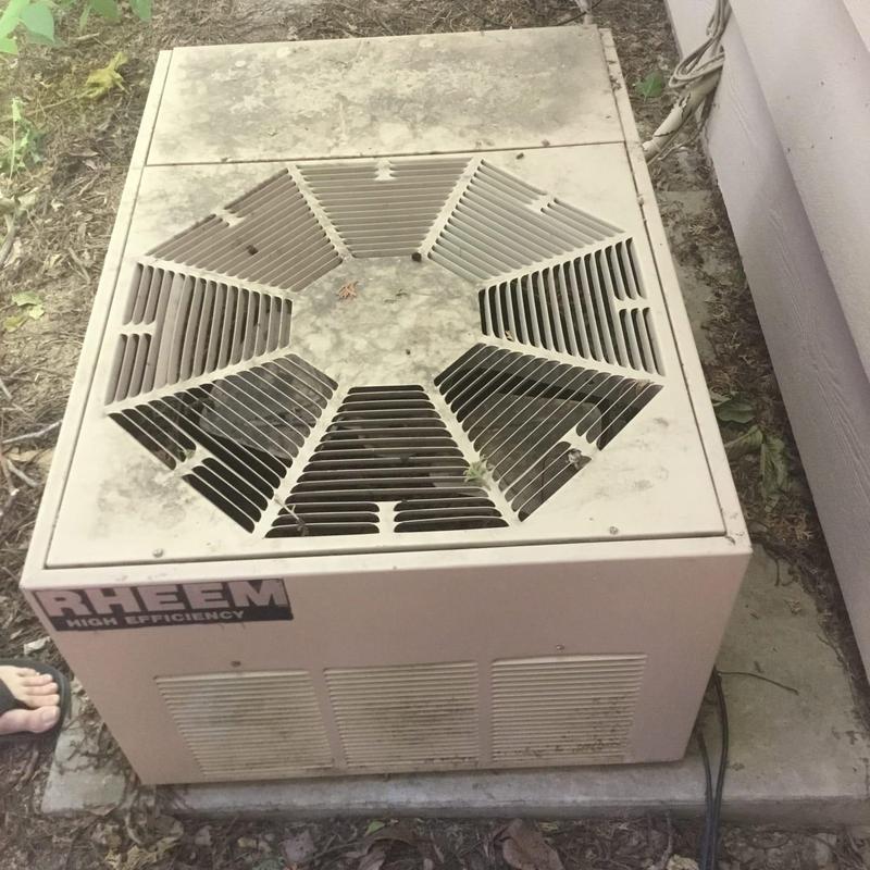 Rheem outdoor HVAC condenser unit with dirty cover
