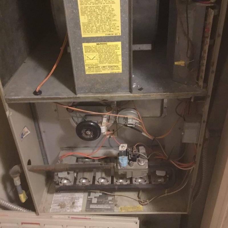 Old HVAC furnace interior with wiring and control parts