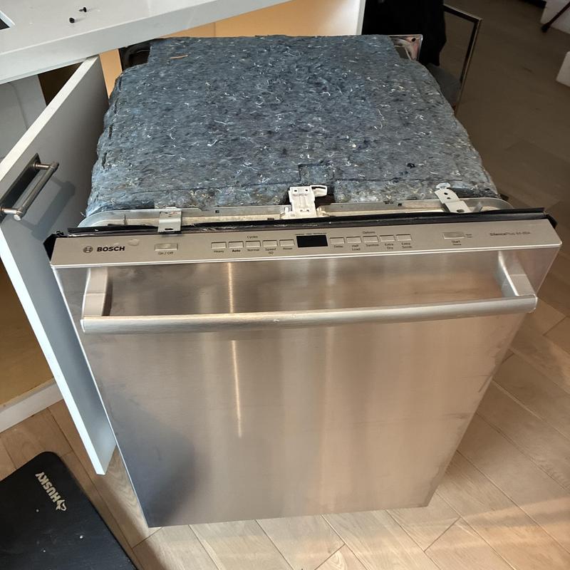 Dishwasher with removed top panel for hose replacement Dishwasher with removed top panel for hose replacement