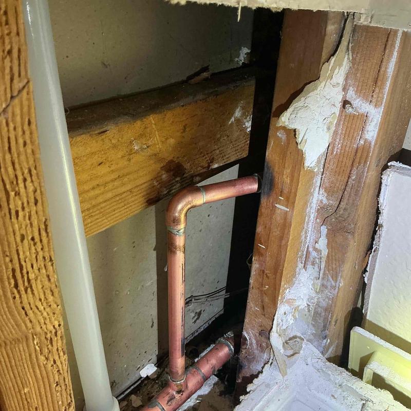 Copper plumbing pipe reroute behind bathroom vanity