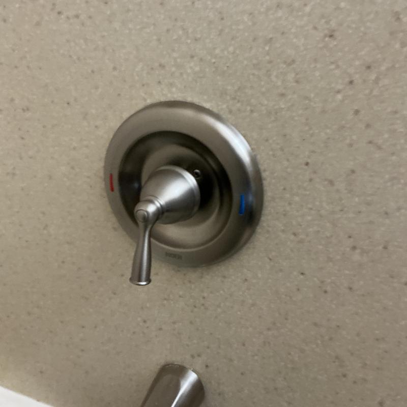 Moen Posi-Temp shower valve handle on wall Moen Posi-Temp shower valve handle on wall