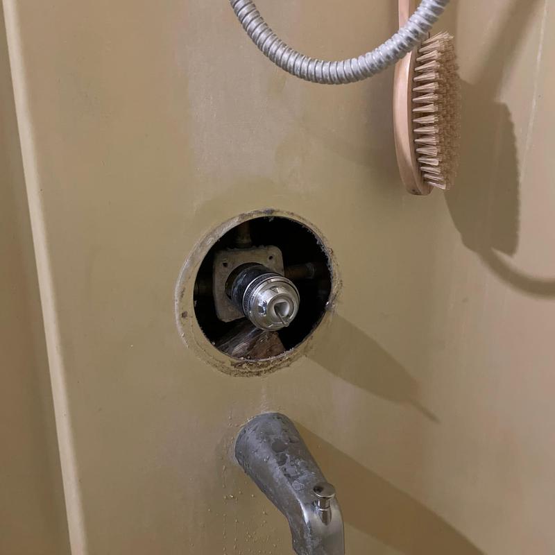 Shower valve cartridge and caulking in bathtub wall