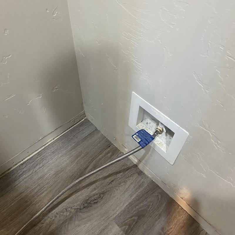 Washer water supply hose connected to wall valve