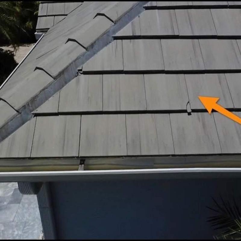 Concrete roof tiles with lifted tile inspection arrow