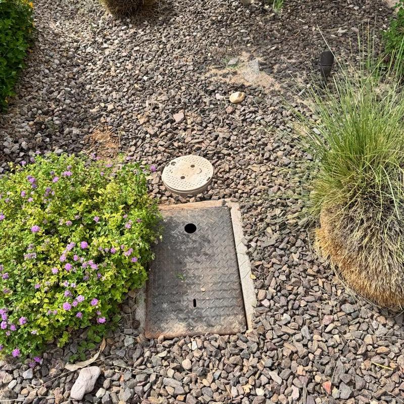 Water main access and irrigation boxes in gravel bed
