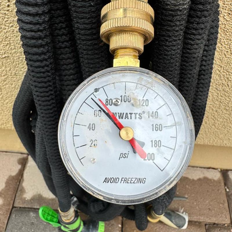 Water pressure gauge at 80 psi before PRV installation