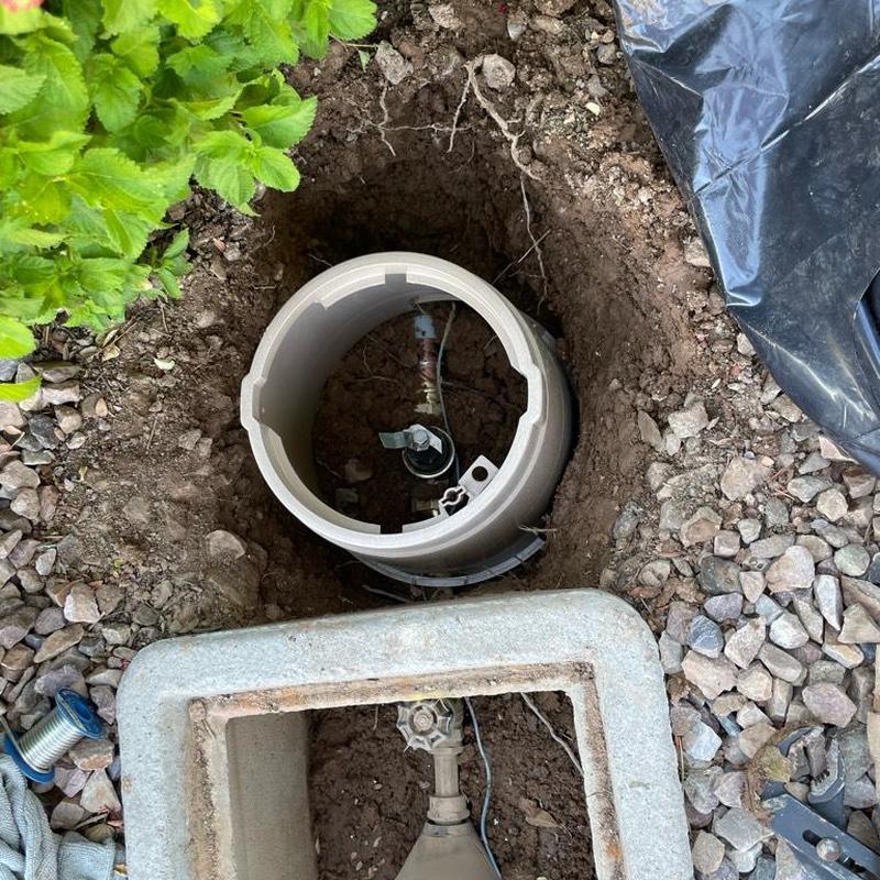 Water meter access box installed in ground with valve