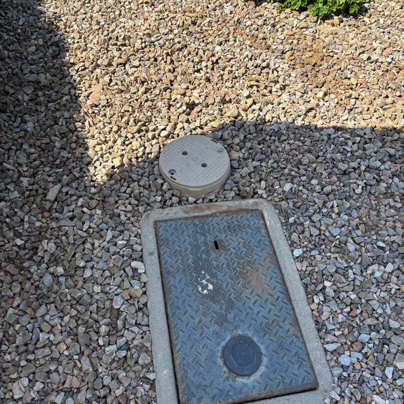 Pressure relief valve with tan access box near water meter