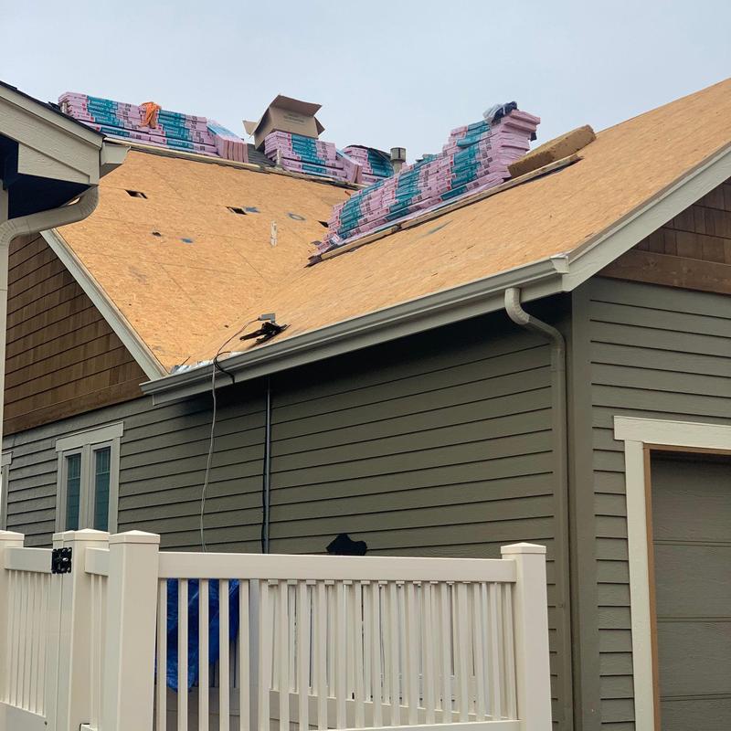 Roof decking replacement with new shingles stacked on top