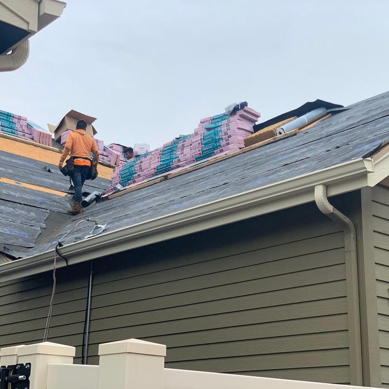 Step flashing installation and shingle delivery on roof