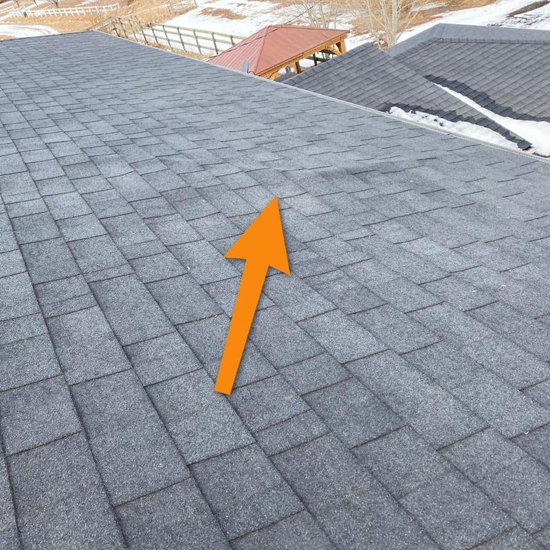 Asphalt shingle roof with inspection arrow