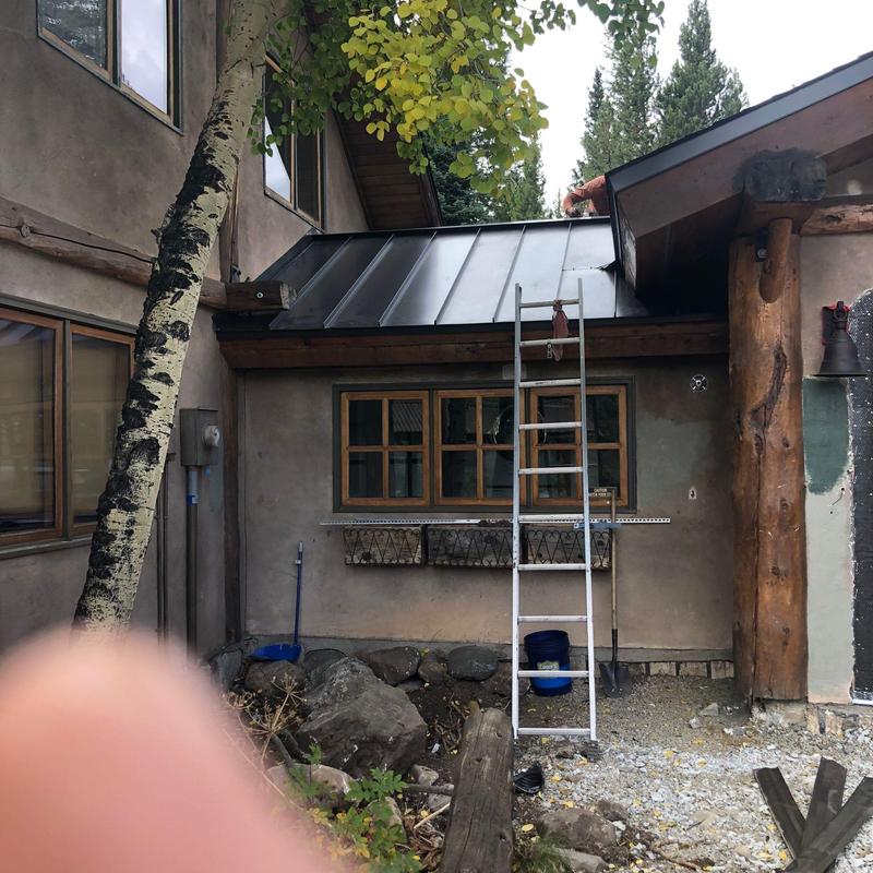 Metal standing seam roof installation on breezeway