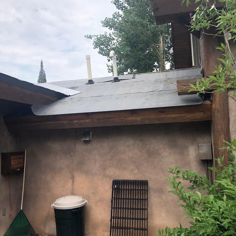 Metal standing seam roof installation on breezeway roof