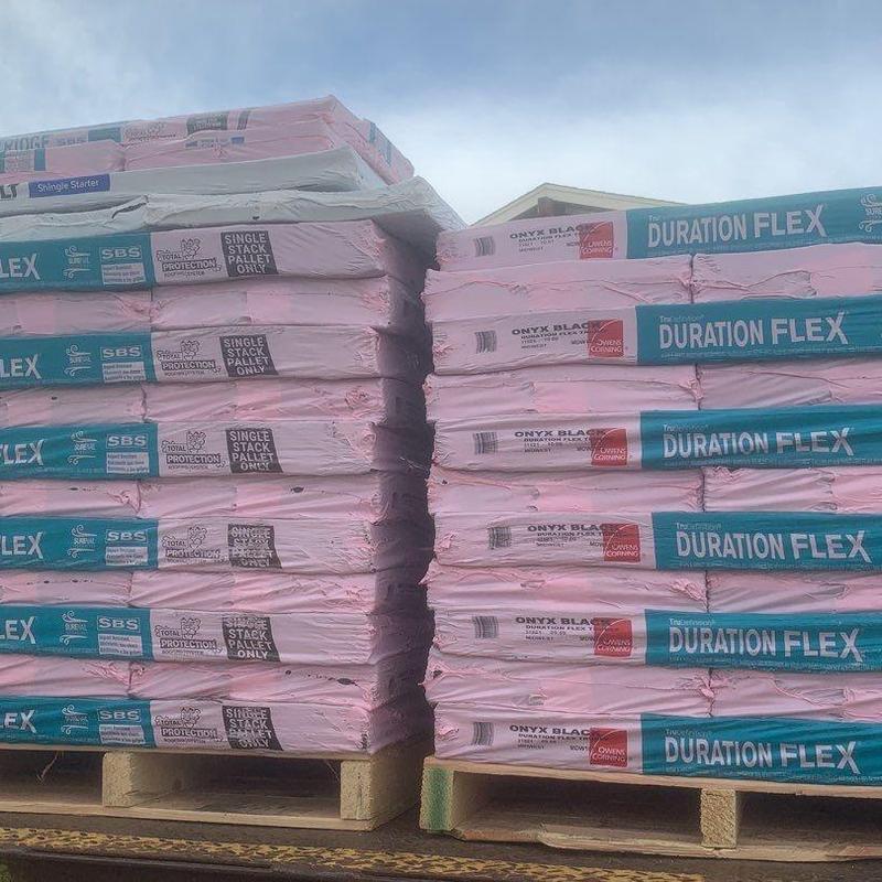 Asphalt shingles stacked on pallets for roofing installation