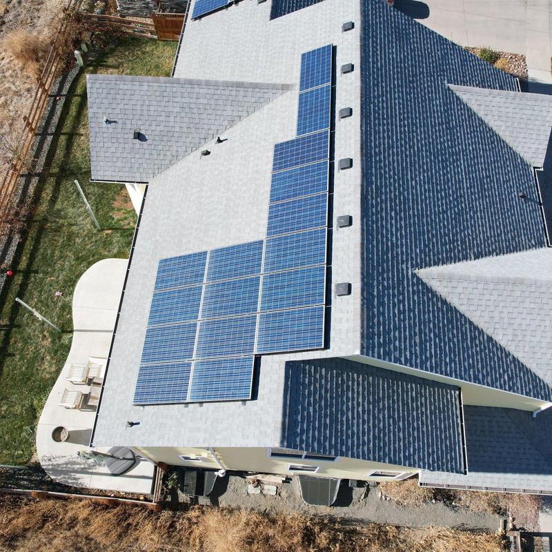 Solar panel array on gray asphalt shingle roof