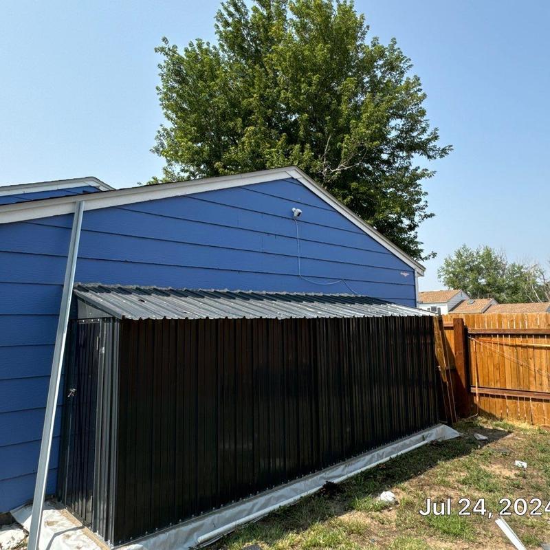 Metal shed roof replacement with black panels