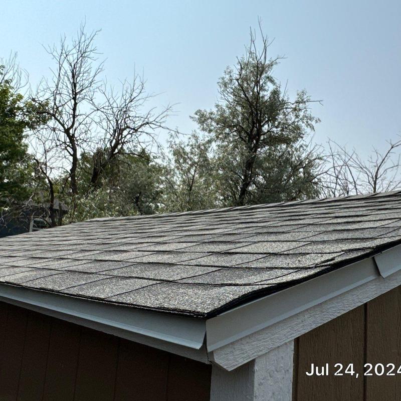 Asphalt shingle roof on detached shed with new gutters