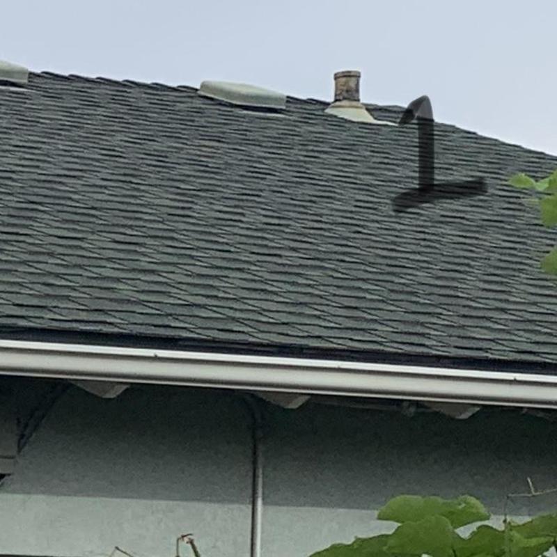 Asphalt shingle roof with vent pipe and number marking