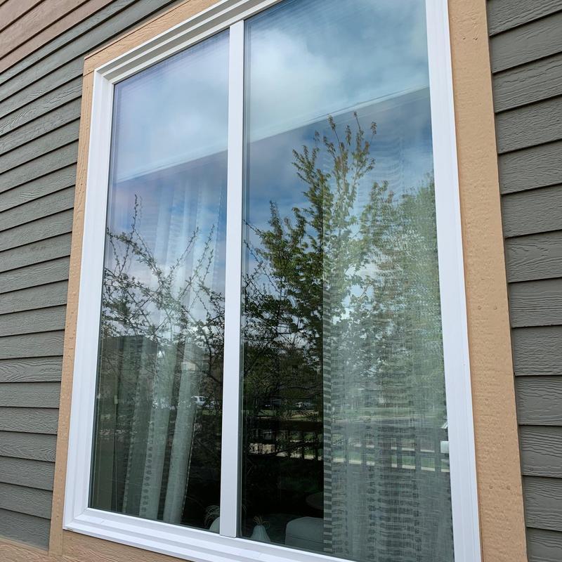 Vinyl sliding window exterior with beige trim