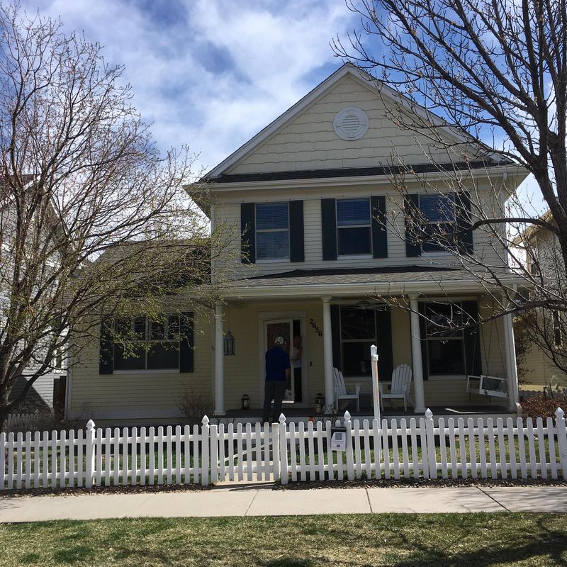 Asphalt shingle roof installation on two-story house