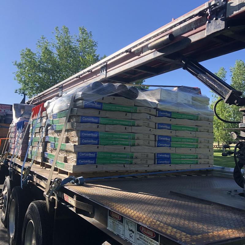 Asphalt roofing shingles stacked on flatbed truck