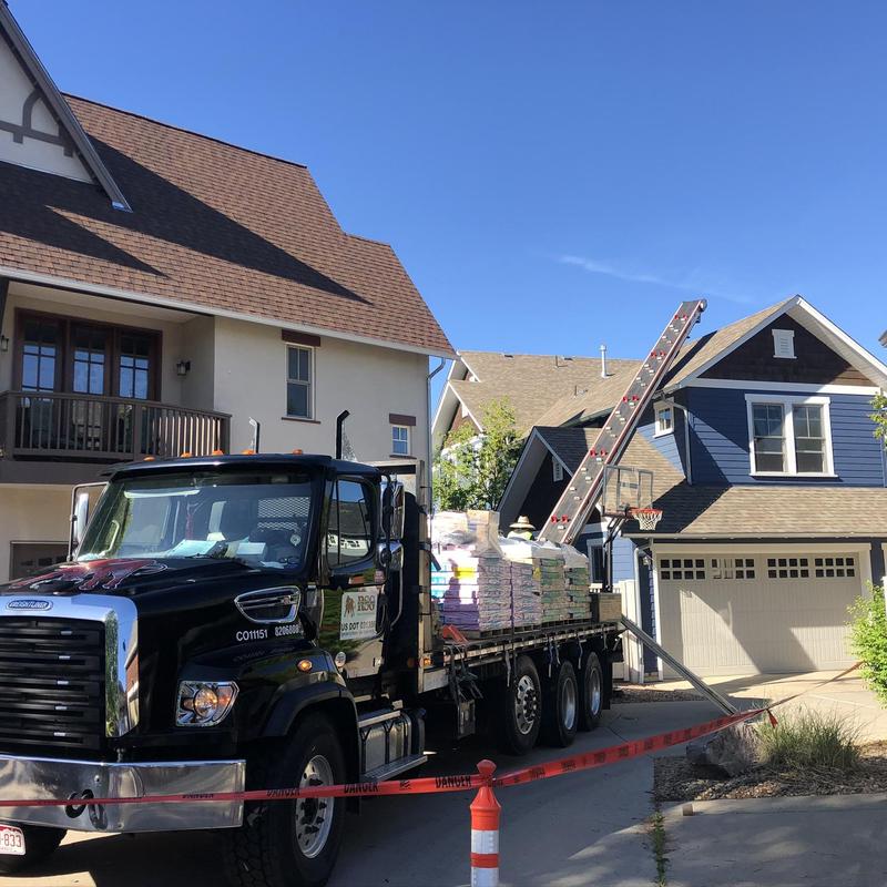 Asphalt roofing materials delivery with ladder lift