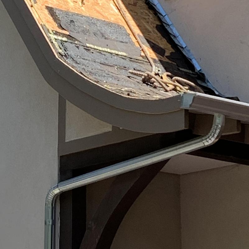 Asphalt roof decking damage and exposed underlayment