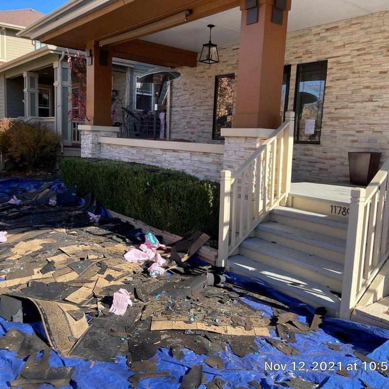Asphalt roofing debris removal on front porch area