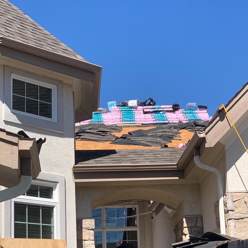 Asphalt shingle roof with new material stacked