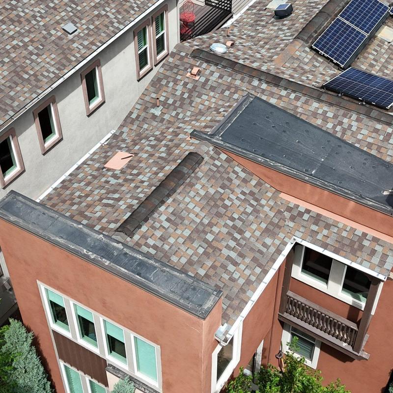 Asphalt shingle roof with solar panels and flashing
