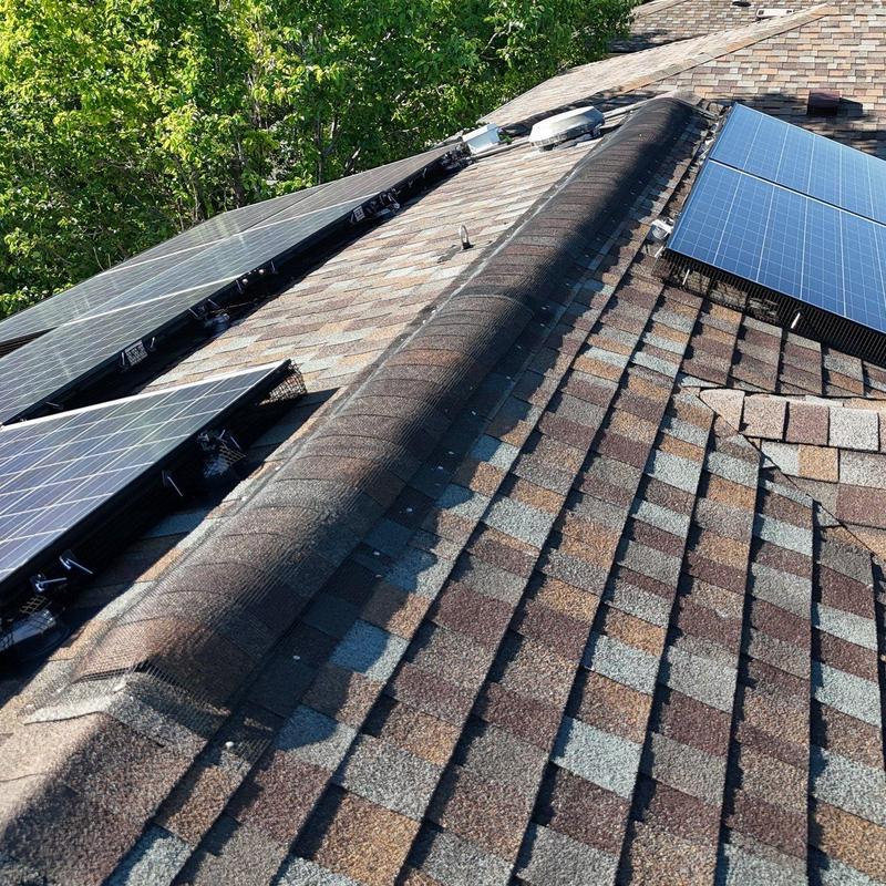 Asphalt shingle roof with solar panel array installation