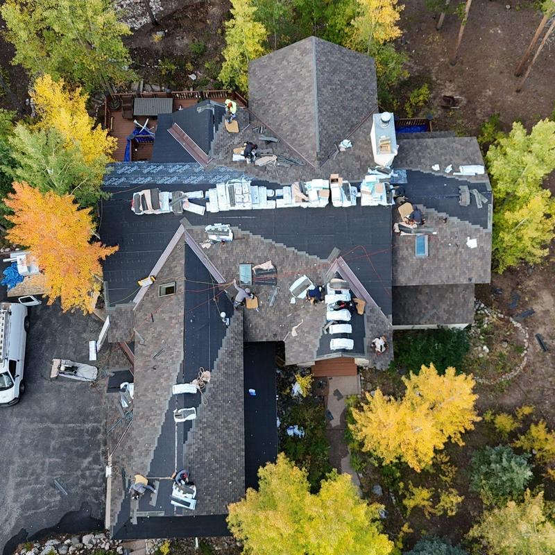 Asphalt shingle roof installation with flashing and underlayment