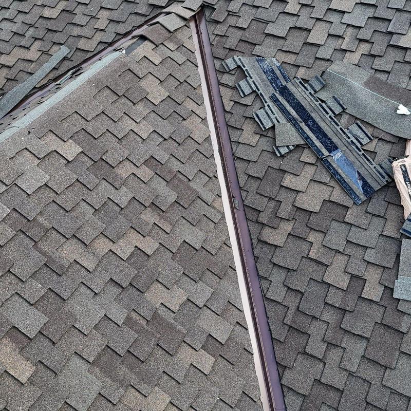Asphalt shingle roof valley with new flashing installation