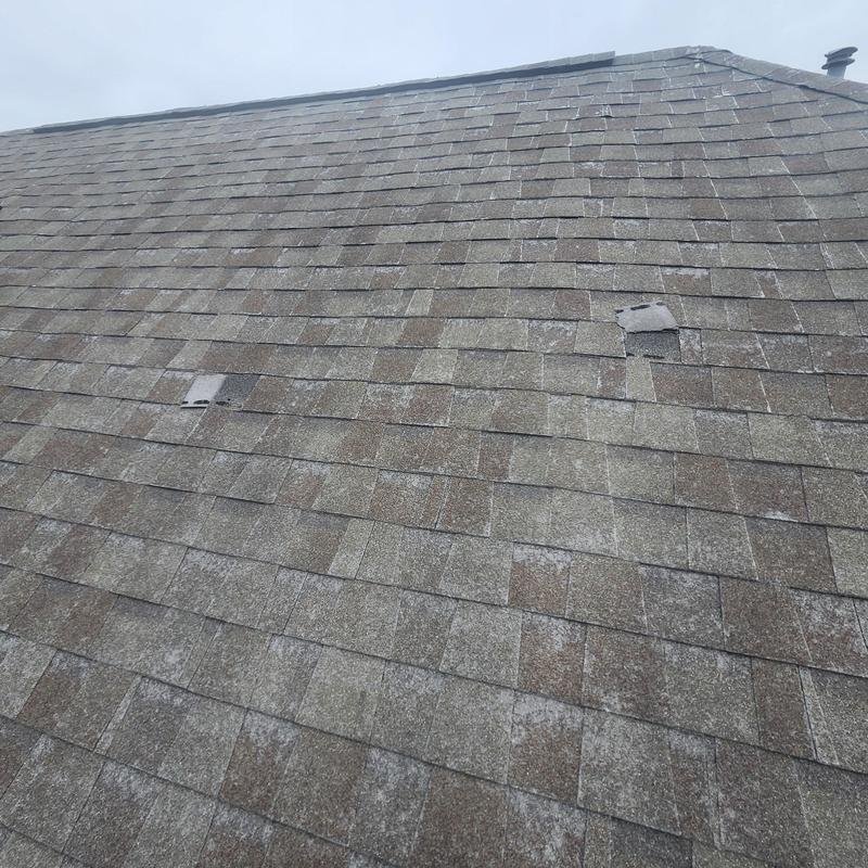 Asphalt shingle roof with hail damage and missing shingles
