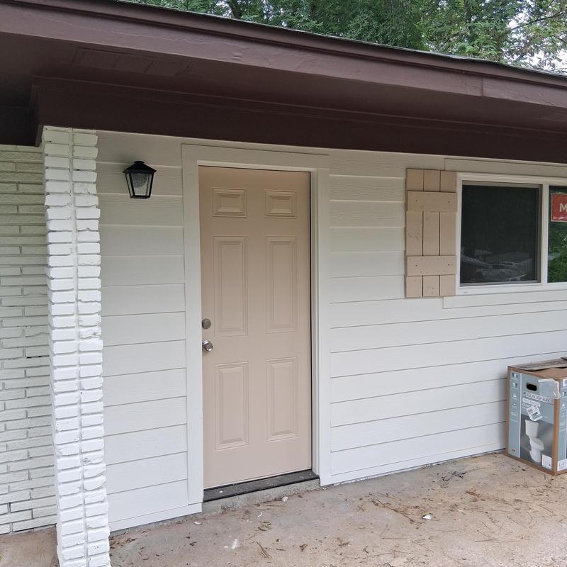 Exterior lighting and shutters on brick wall