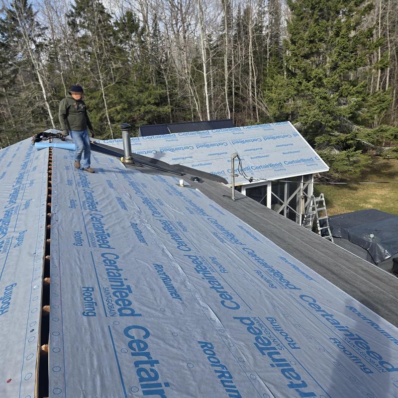 Roof underlayment installation on sloped residential roof