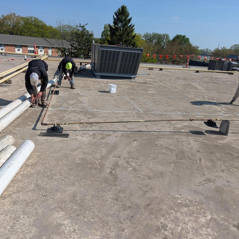 TPO single ply flat roof with worker installation