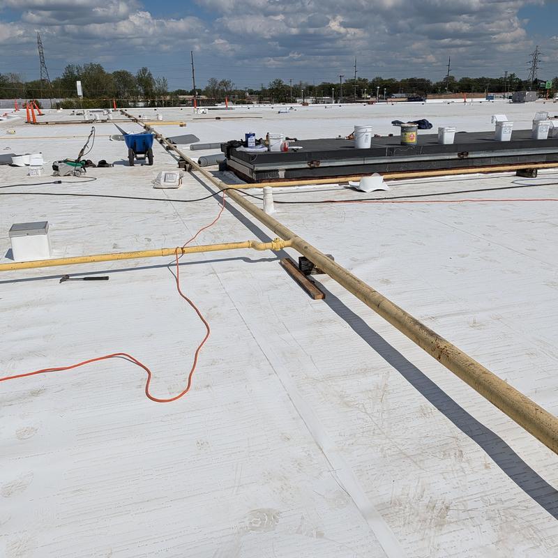 TPO single ply roof with pipes and tools