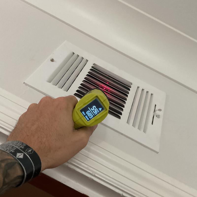 HVAC vent temperature check with handheld infrared tool