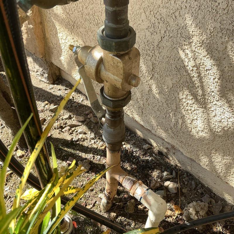 Pressure regulator valve installed on outdoor plumbing line