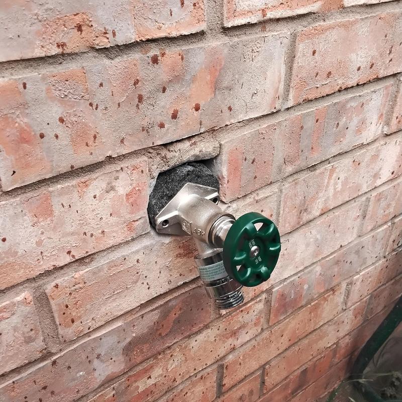 Frostproof hose bib installation in brick wall with insulation