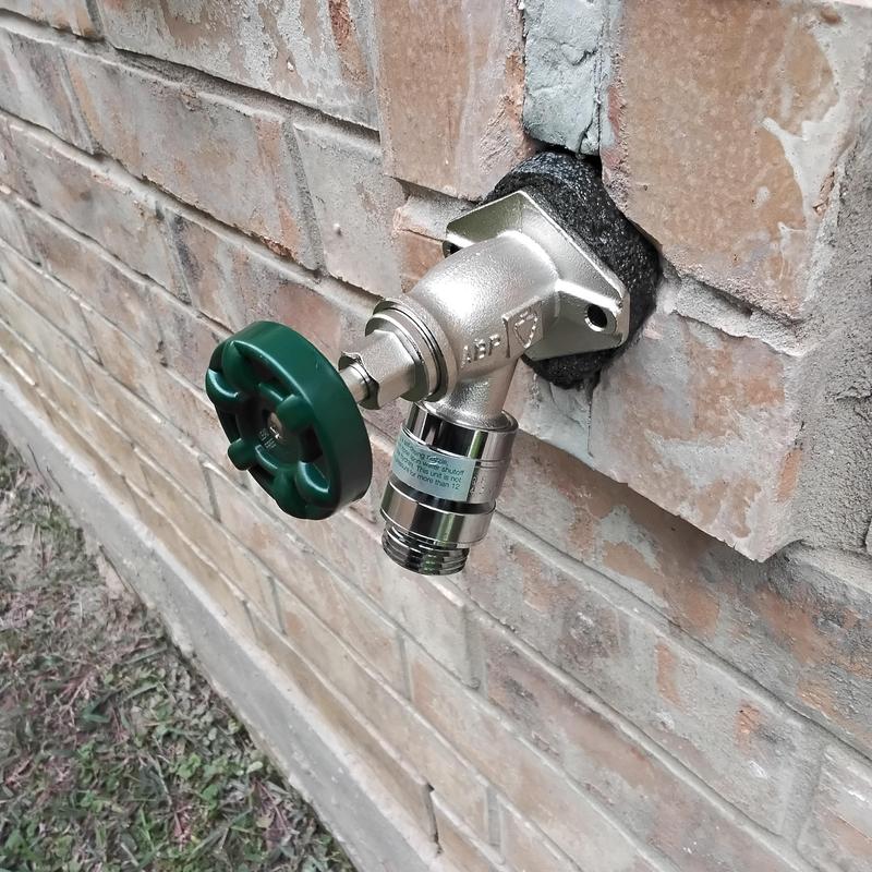 Frostproof hose bibb with green handle and insulation