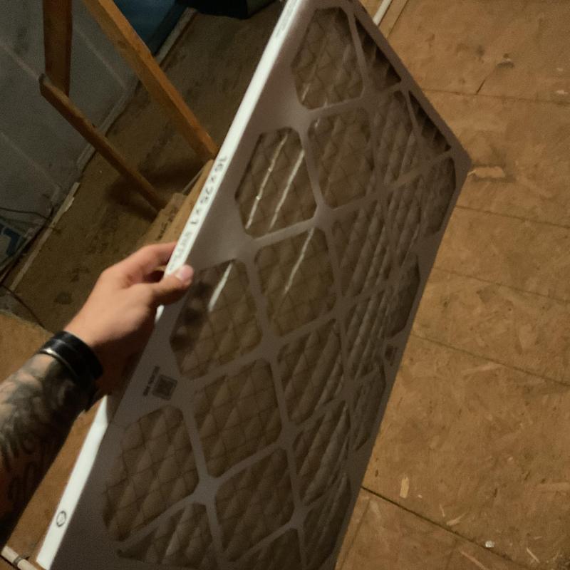 HVAC air filter held during inspection and replacement