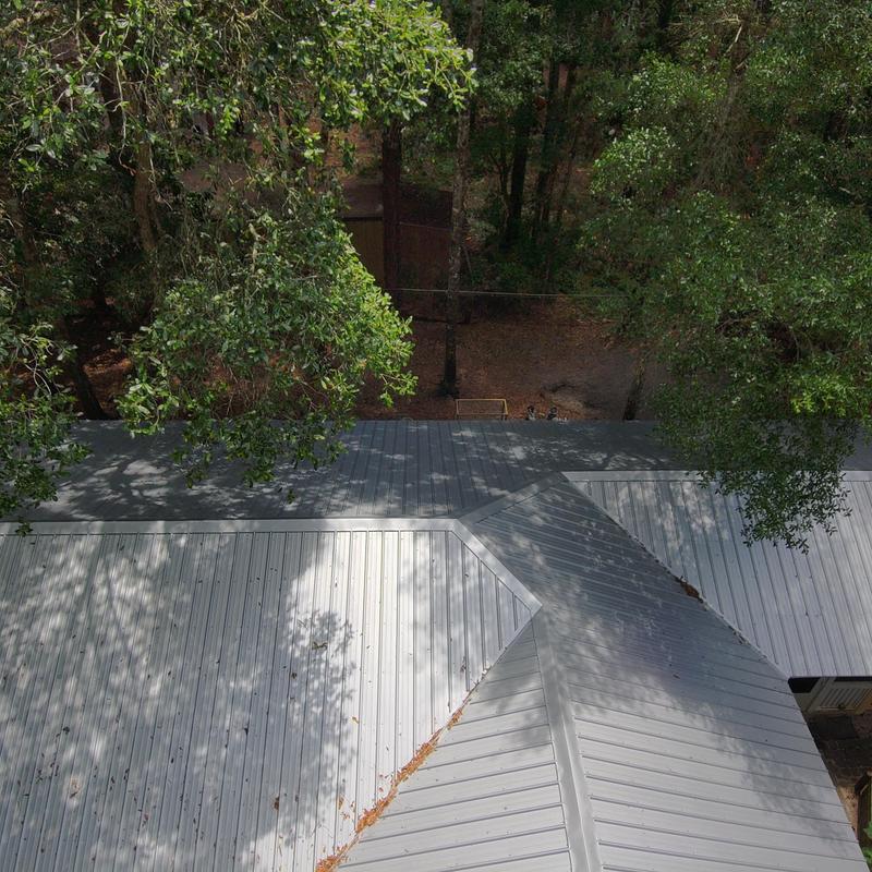 26 gauge metal roof installation with tree shadows 26 gauge metal roof installation with tree shadows