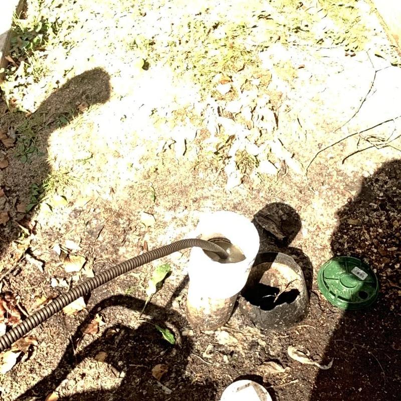 Main sewer line with plumbing auger for unclogging
