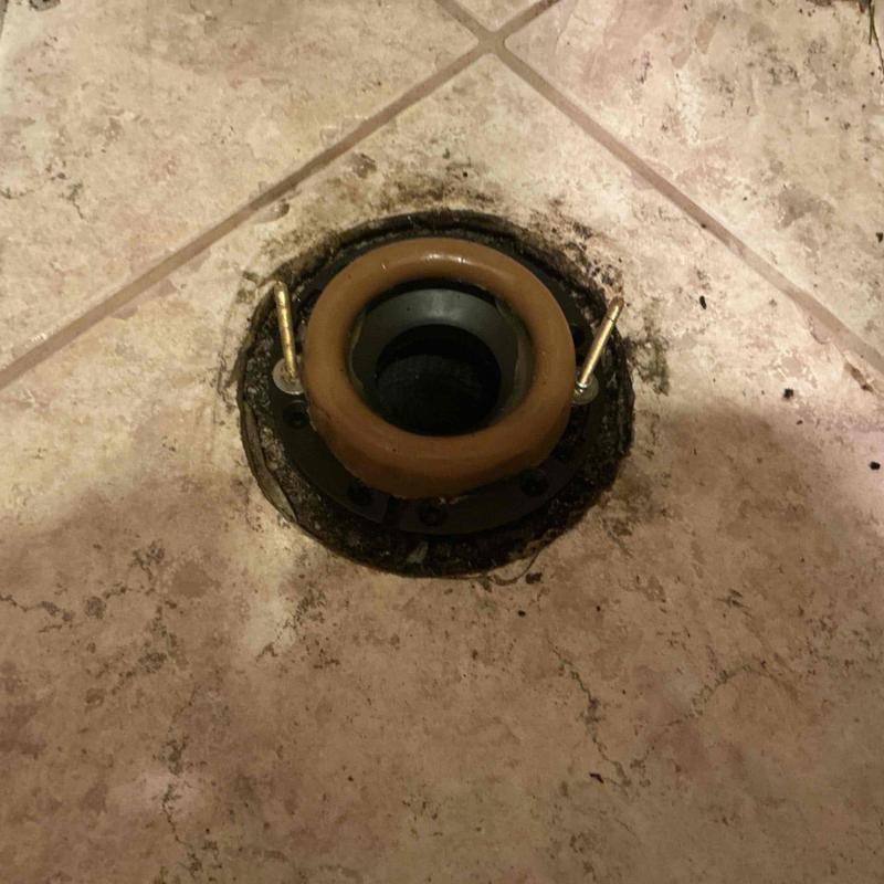 Toilet flange with wax ring installed on floor drain