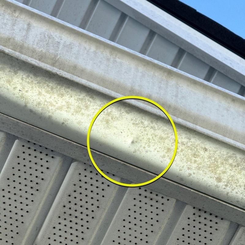 Metal gutter with surface corrosion and discoloration